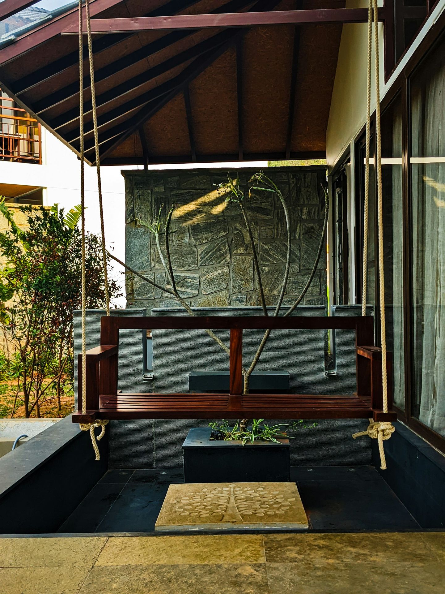 a wooden bench sitting under a wooden roof
